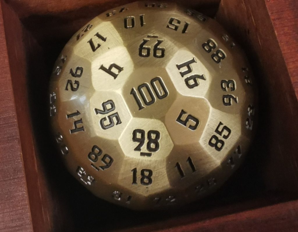 Metal D100 in a wooden box.